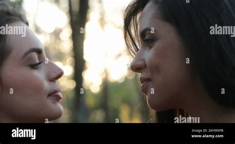 Two girls french kissing outside at the park. LGBT lesbian couple。